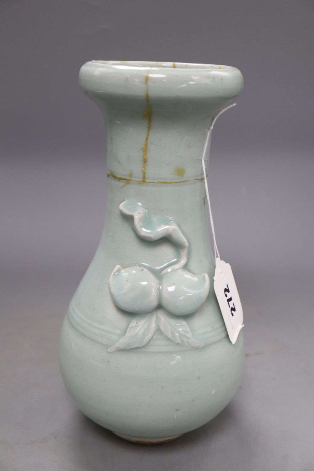 A 17th century Chinese celadon glazed vase, height 26.5cm (a.f) and a pin dish